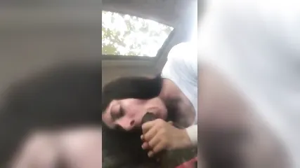 Возбужденная белая шлюха в одежде дрочит двумя руками хуй и делает негру глубокий минет